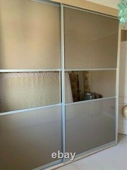Fitted wardrobes with two sliding doors in beige and mirror finish rarely used